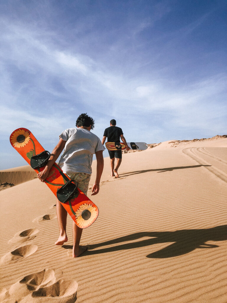 Men on the Tamri Sandunes sandboarding