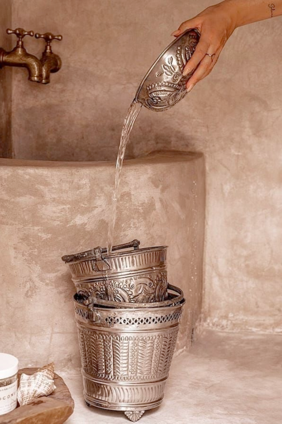 Woman pouring water for an traditional hamam massage