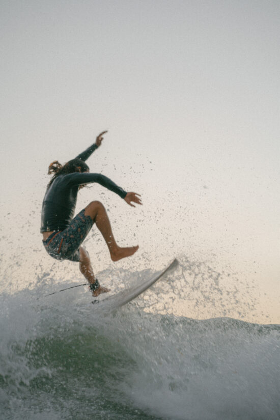 Advanced surfer doing manuver at anza beach, Agadir