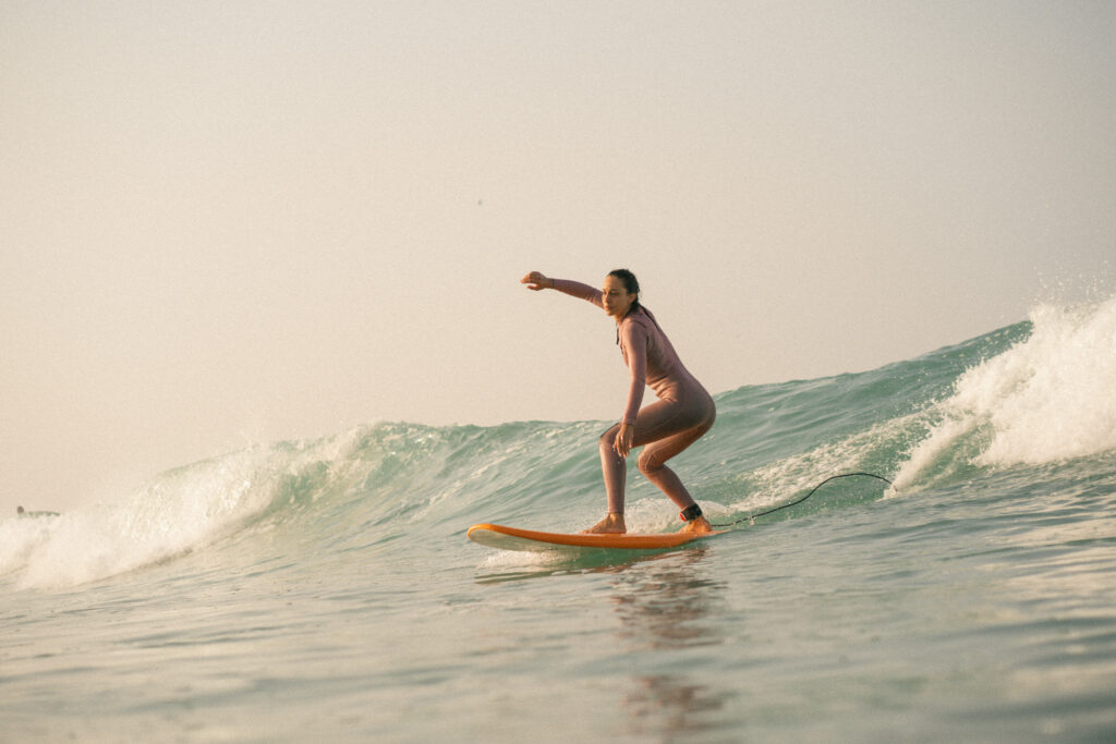 Intermeditae surfer catches green waves at anza beach, agadir