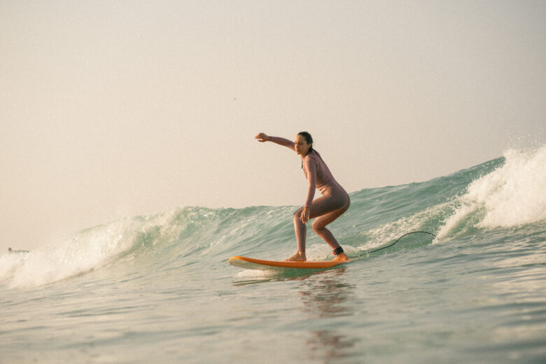Intermeditae surfer catches green waves at anza beach, agadir at Anza Surfhouse surf camp