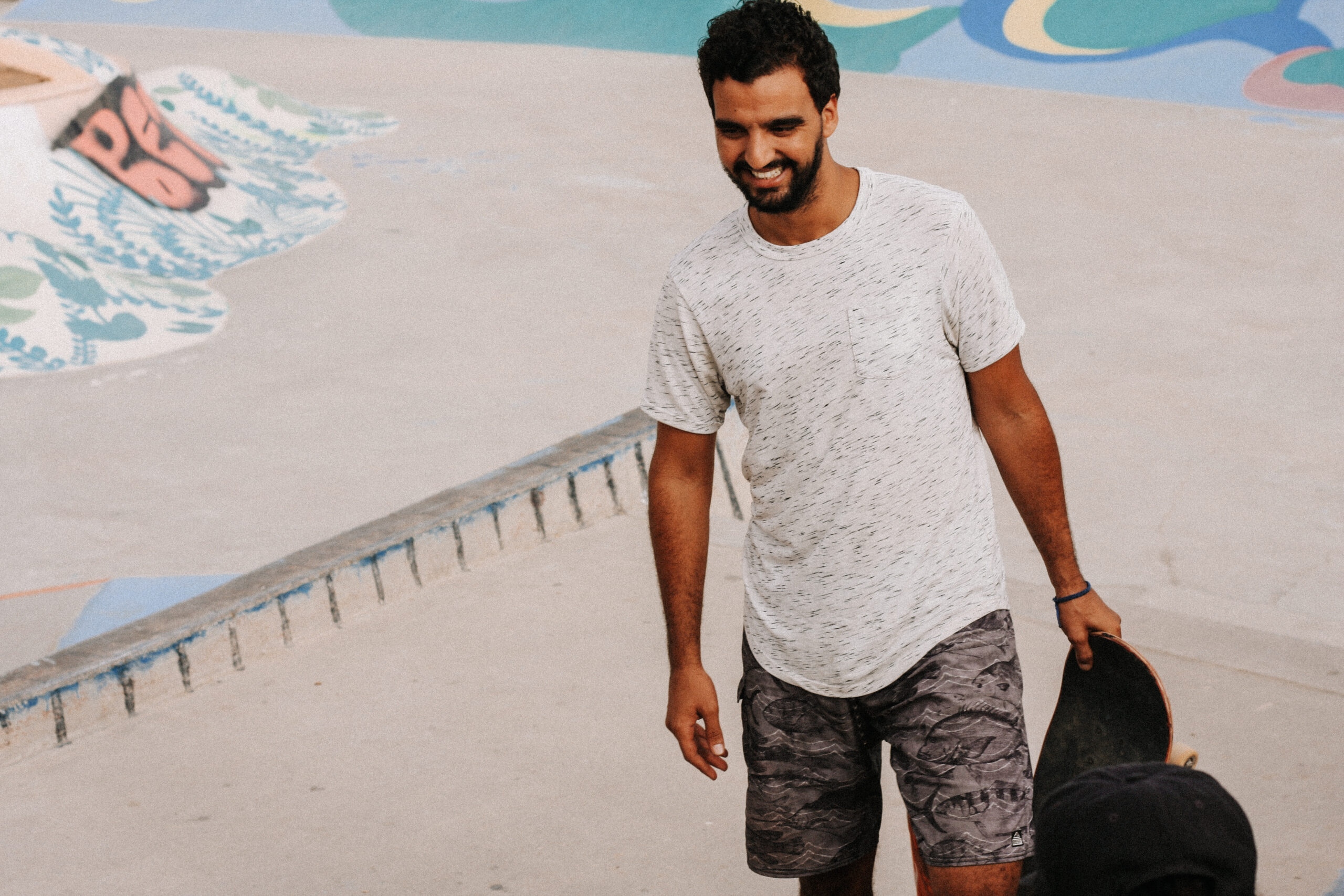 Karim laughing with someone at taghazout skatepark