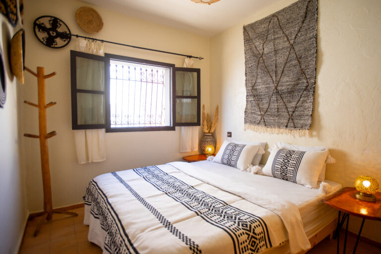 double room with wall decorations and double bed at Anza Surfhouse Surf camp