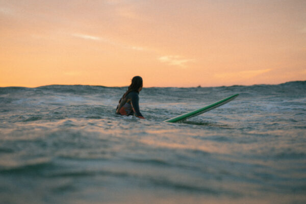 Women enjoying a sunset surf in Anza, Agadir