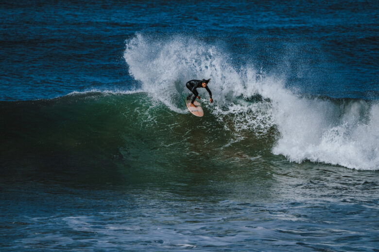 Man surfing a wave in Anza, Morocco